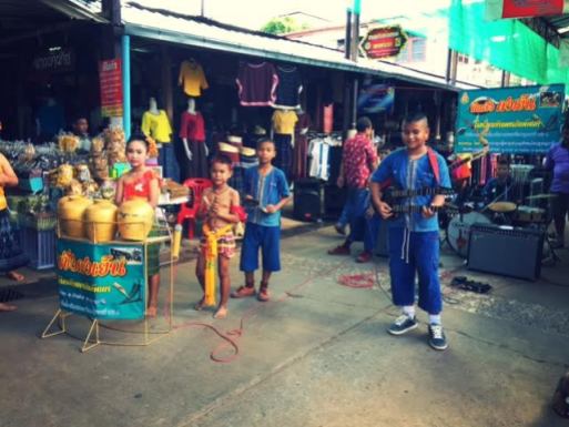 Children play in a band in the local outdoor market.
